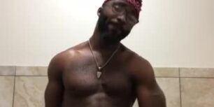 Muscular black guy stroking his dick in the gym bathroom