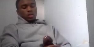 Young black stroking his cock during a work break