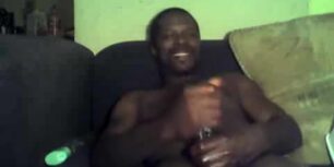 Horny black dad stroking his beefy fat cock solo on his sofa