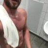 Stud wanking in a public toilet with a happy face