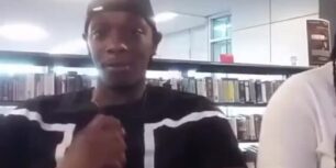 Horny college black dude rubbing his cock in a public library