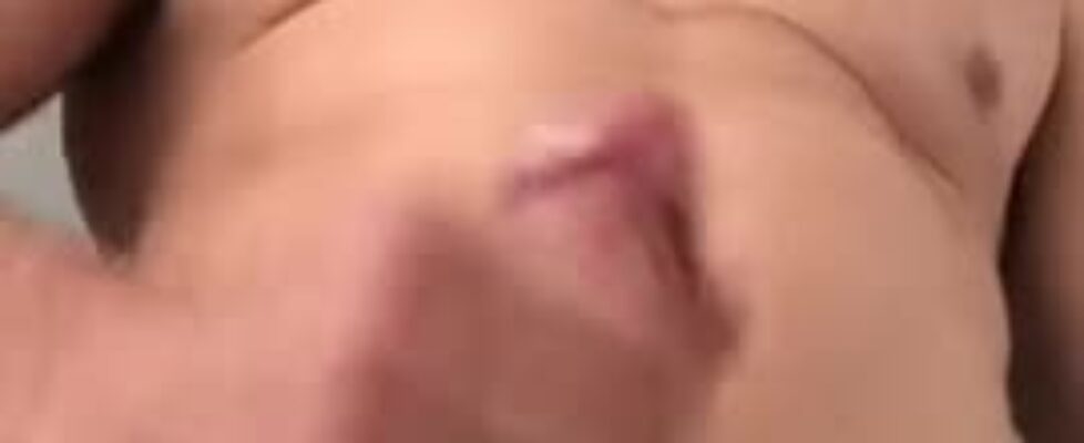 Sexy stud rubbing his huge cock solo