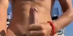 Cute young stud rubbing his huge cock hard in his boat